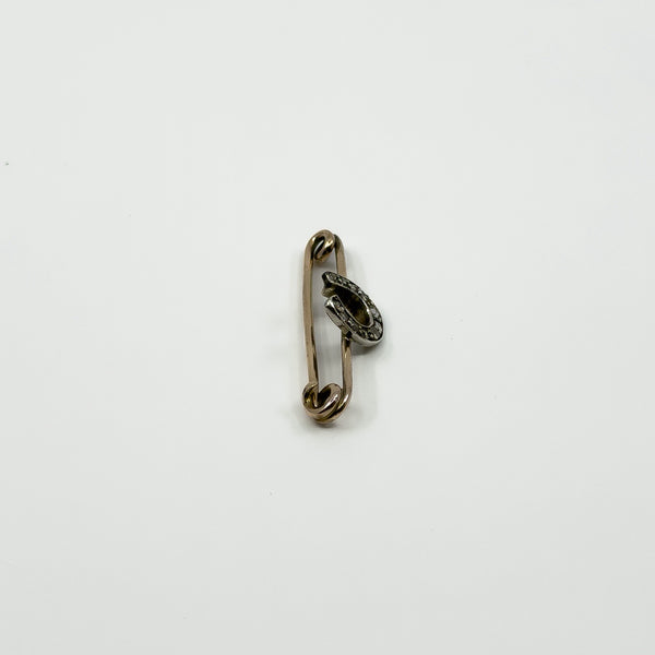 Side detail of antique 9ct gold brooch showing raised silver horseshoe and pin fitting
