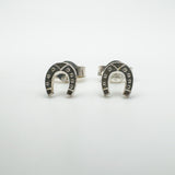 Close-up front shot of silver horseshoe earrings with square detailing