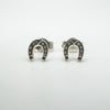 Close-up front shot of silver horseshoe earrings with square detailing