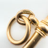 Inner jump ring stamped 375 on antique gold T-bar pendant