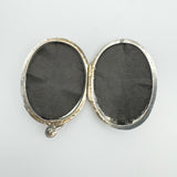 Interior of vintage sterling silver locket showing photo compartments