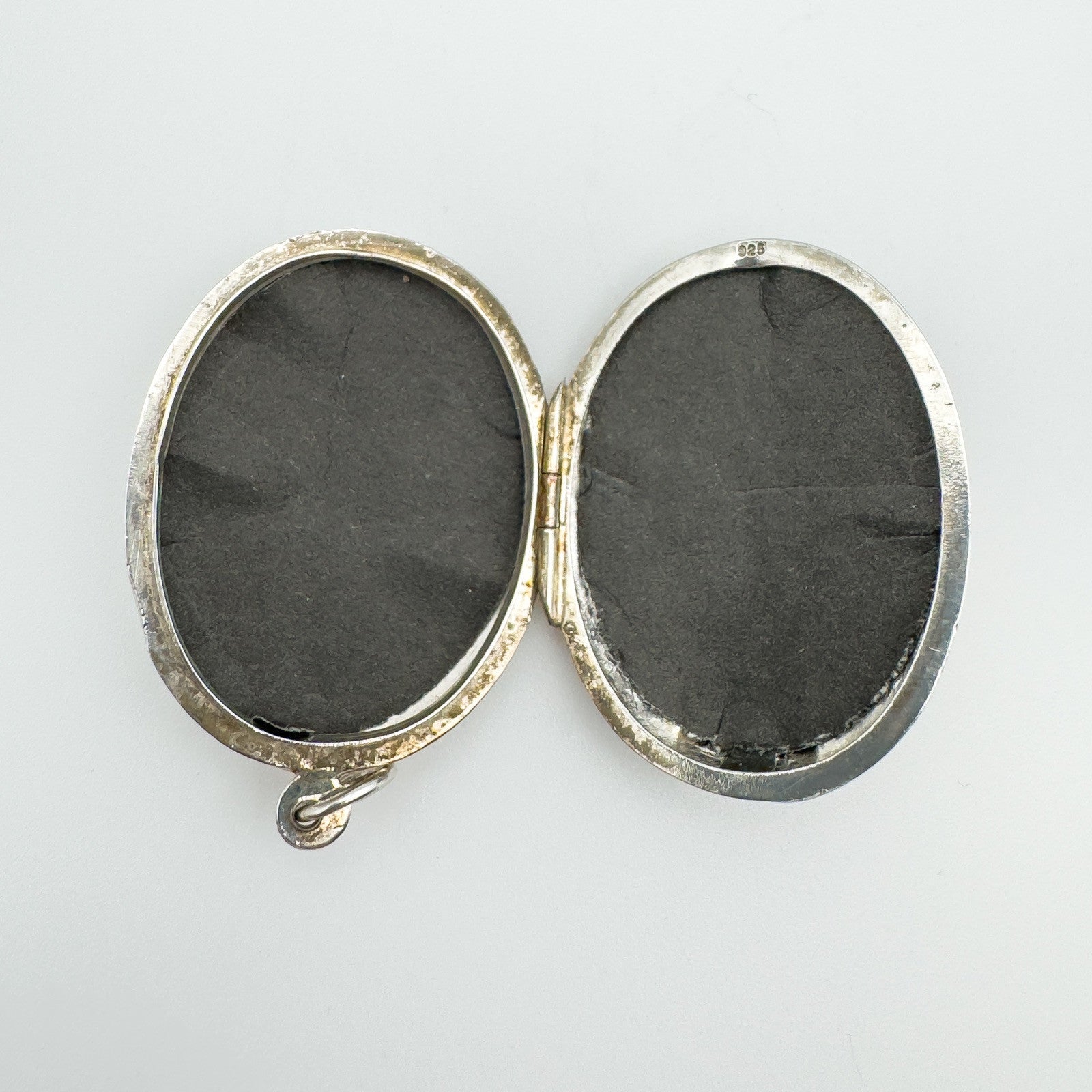 Interior of vintage sterling silver locket showing photo compartments