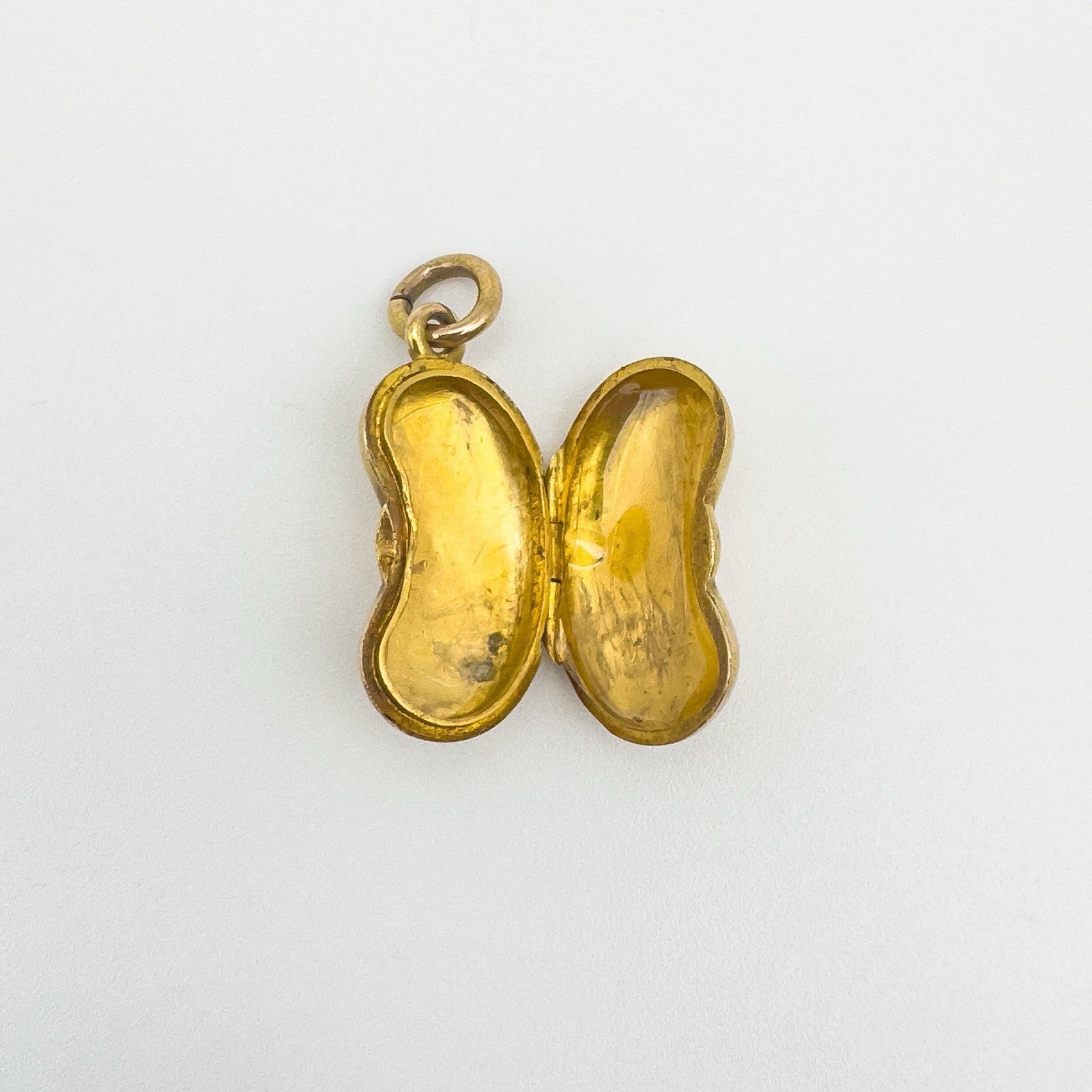 Open view of 18ct gold kidney bean locket showing original photo compartments
