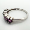 Close-up of sterling silver ring interior showing 925 hallmark and pink garnet stone edges