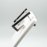 Sterling silver J hoop earrings with pink sapphires and diamond shown on a white display stand