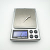 Digital scale displaying 2.1g weight of sterling silver tooth pendant charm