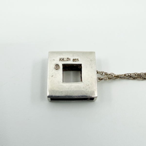 Back of Kit Heath sterling silver pendant showing KH 01 and 925 stamps