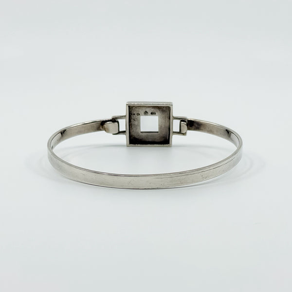 Interior view of Kit Heath sterling silver mother of pearl bangle showing the back of the square centre panel