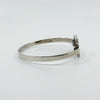 Side profile of vintage sterling silver Kit Heath bangle showing the slim polished band and front panel