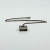 Side view of the Kit Heath mother of pearl pendant with sterling silver chain attached