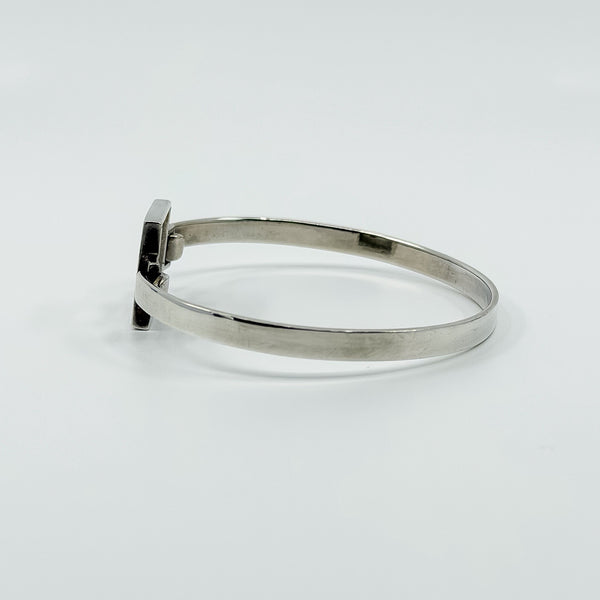 Opposite side view of vintage Kit Heath sterling silver bangle with smooth slim band and square front