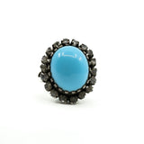 Large sterling silver turquoise and diamond halo ring shown from the front