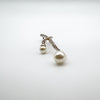 Close-up of two pearl drops on silver pendant with CZ stones