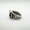 Angled close-up of leaf and 3D flower motif on chunky sterling silver ring