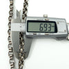 Calipers measuring the width of the sterling silver Albert chain links (6.93mm shown).