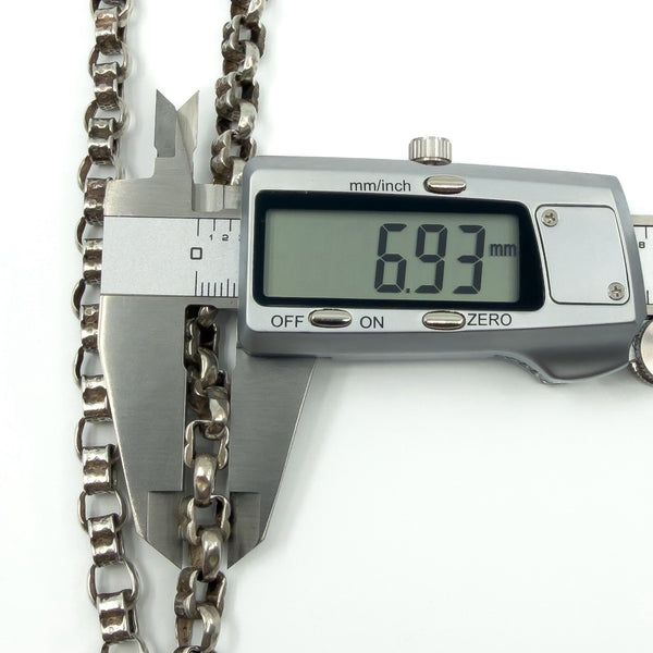 Calipers measuring the width of the sterling silver Albert chain links (6.93mm shown).
