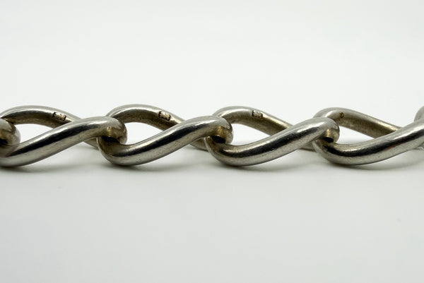 Close up of lion passant stamps on oval links of antique sterling silver Albert chain