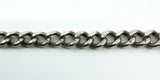 Close-up of the Albert chain links showing repeated lion passant stamps along the sterling silver links.