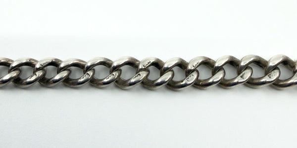 Close-up of the Albert chain links showing repeated lion passant stamps along the sterling silver links.