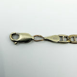 Close up of the lobster clasp, 375 stamps and connecting link on a 9ct white gold mariner bracelet