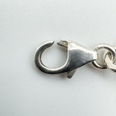 Detailed view of lobster clasp stamped 925 on sterling silver bracelet