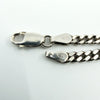 Close-up of the lobster clasp on the sterling silver curb chain, showing the 925 stamp.