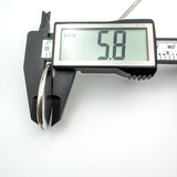 Depth of vintage silver locket measured at 5.8mm using digital calipers