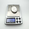 Digital scale showing the chunky sterling silver locket weighs 12.56 grams