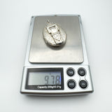 Chunky vintage silver locket on digital scales weighing 9.78 grams