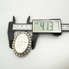 Digital caliper showing width of vintage silver locket as 41.3mm