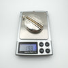 Vintage sterling silver locket shown on digital scale reading 19.81 grams