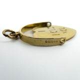 Close-up of 9ct gold fob pendant hallmarks showing 9, 375, London leopard head and date letter