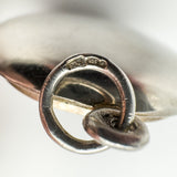 Close-up of CME, 925, and triangle import marks on locket bail