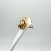 9ct rose gold lovers knot earrings displayed on white stand, vintage textured design