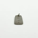 Low side view of sterling silver ingot pendant with Birmingham hallmarks and attached jump ring.