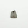 Low side view of sterling silver ingot pendant with Birmingham hallmarks and attached jump ring.