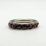 Low angle close-up showing garnet settings and silver ring profile