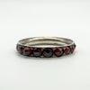 Low angle close-up showing garnet settings and silver ring profile
