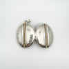 Both sides of the sterling silver locket with mirrored foliate pattern and central rope
