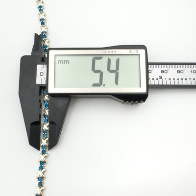 Measuring width of blue CZ tennis bracelet at 5.4mm