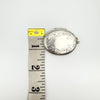 Width of foliate oval sterling silver locket shown next to measuring tape