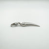 Underside of silver horn charm showing smooth curved finish and pointed tip