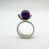 Front view of vintage modernist ring with deep amethyst ball in sterling silver