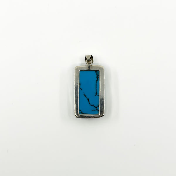 Sterling silver modernist turquoise pendant showing rectangular bezel setting and black vein detail