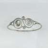 Detailed image of spiral front design with bezel-set oval mother of pearl