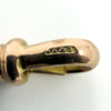 Close up of the NA and S stamp on the 9ct rose gold dog clip of an antique Albert chain