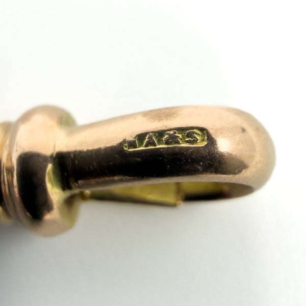 Close up of the NA and S stamp on the 9ct rose gold dog clip of an antique Albert chain