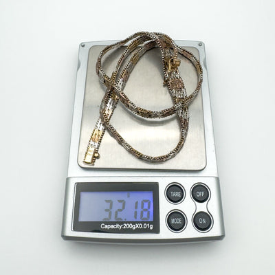 Tricolour necklace weight shown as 32.18 grams on digital jewellery scale