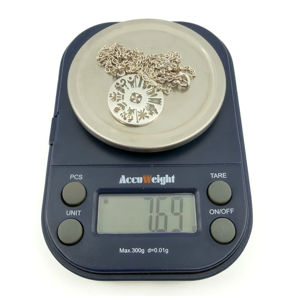 Pendant and chain on scales showing 7.69g total weight for sterling silver History of Ireland necklace.
