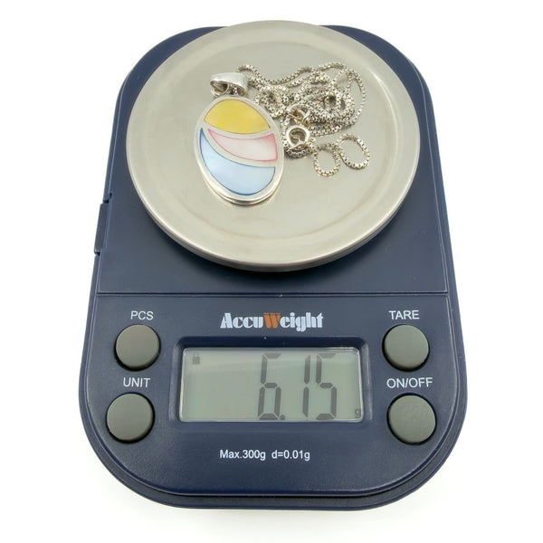 Sterling silver oval pendant necklace with blue, pink and yellow inlay, shown weighing 6.15g on digital scales.